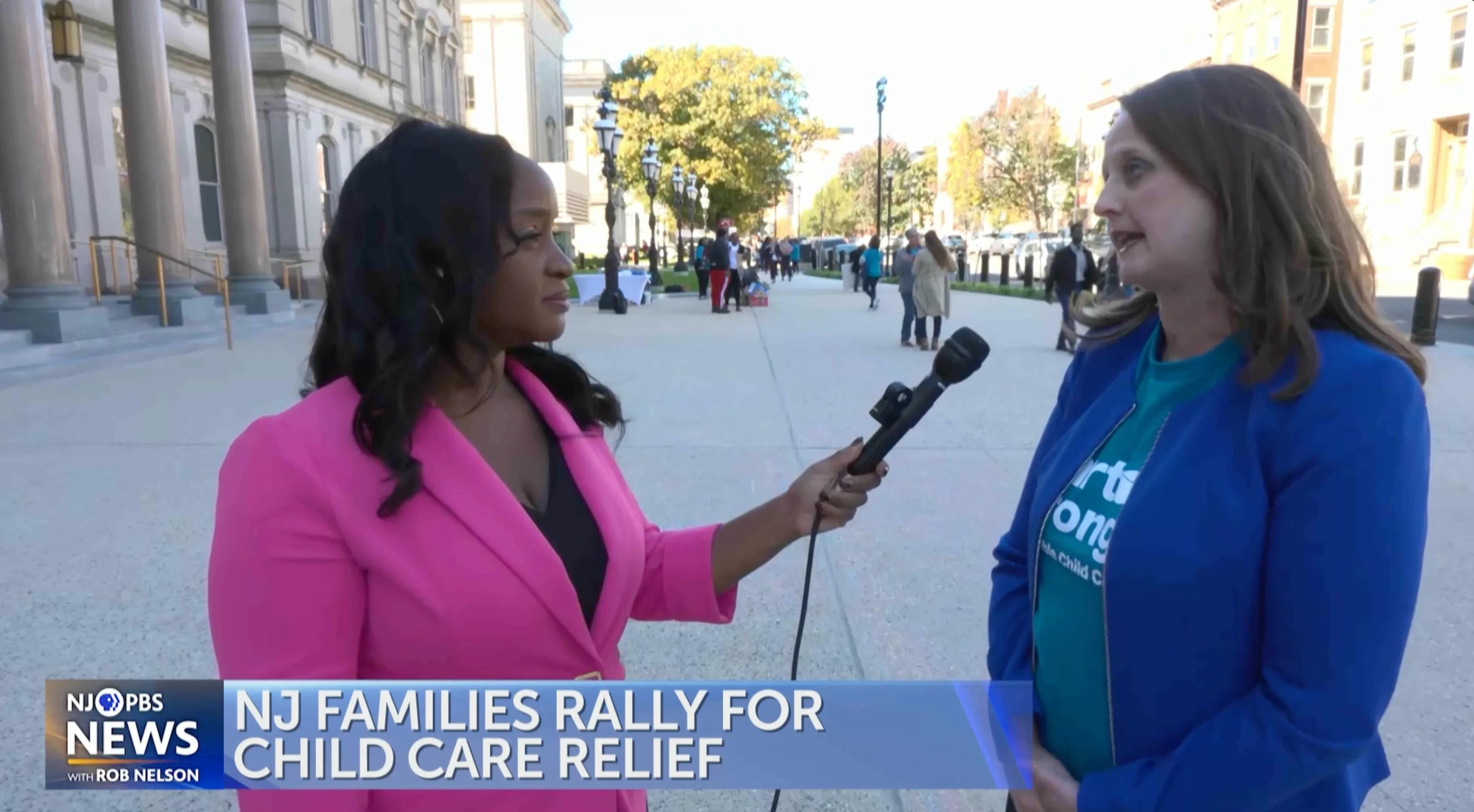 an image of NJ PBS reporter Asha McKenzie speaking to a guest about New jersey child care costs in front of a courthouse